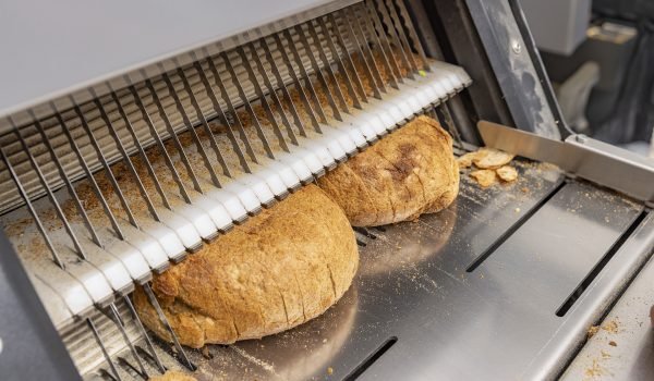 Bread slicing machine. Sliced bread on the production line of food and bakery products.